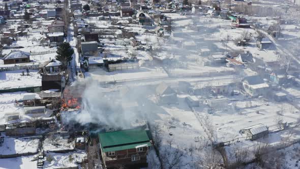 Aerial View of Firefighters Extinguishing a House in the Village