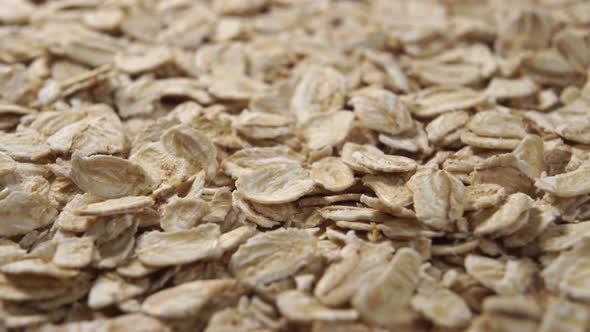 A pile of raw coarse cereal oat flakes