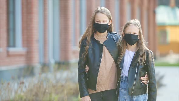 Girls Wearing a Mask on a Background of a Modern Building,