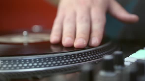 Hip hop dj scratches records on turntables in close up footage clip