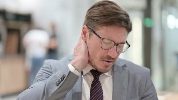 Portrait of Stressed Businessman Having Neck Pain