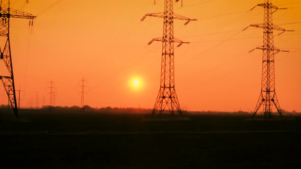 Electricity Towers In The Wheat Field At Sunset