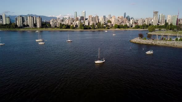 Sailboats On The Calm Water Near The Kitsilano Beach With Downtown Skyline And English Bay Beach On