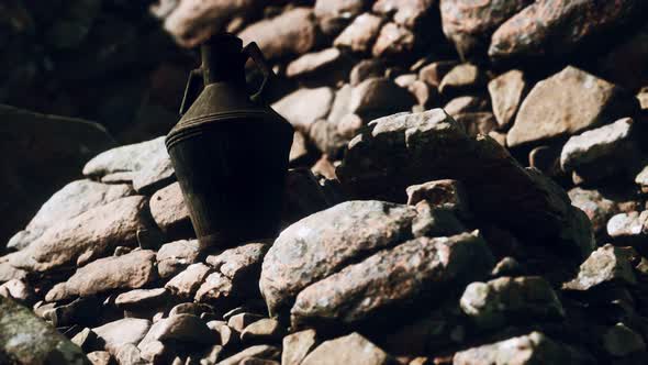 Old Metal Jug at Rocks alt