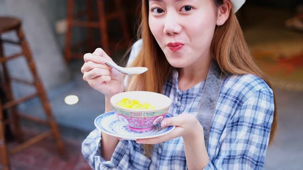 Asian Young woman  Eating Traditional Asian Street Food