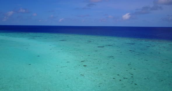 Natural birds eye tourism shot of a paradise sunny white sand beach and aqua turquoise water backgro