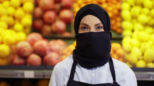 Portrait of Supermarket Female Muslim Worker Standing with Fruit Department on Background