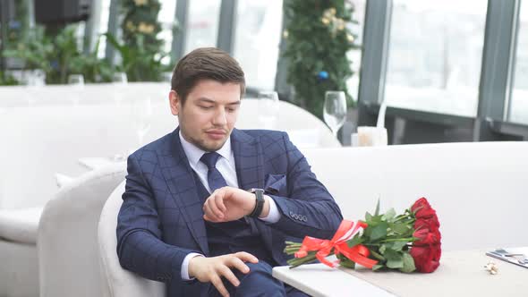 Young Caucasian Man Sit Waiting for Girlfriend in Restaurant