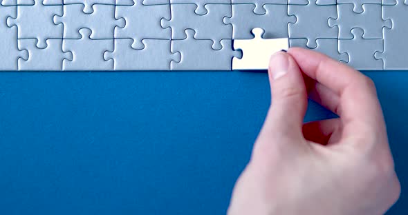 Grey puzzles isolated on blue background. Social issue concept