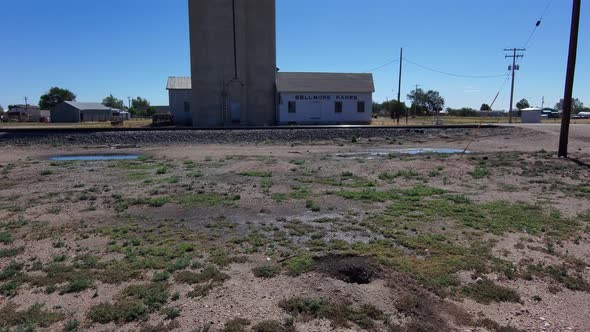 Slow dolly forward toward old grain silo and shop in Nunn Colorado.