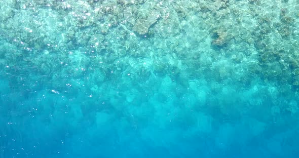 Beautiful birds eye clean view of a white paradise beach and blue water background in colorful 