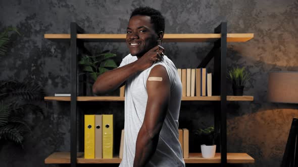 African American Man Patient Show Medical Plaster Demonstrates Vaccine Injection