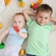 Portrait of Smiling Baby Boy with Older Brother Playing Toy Bricks and Blocks While Lying on Carpet - VideoHive Item for Sale