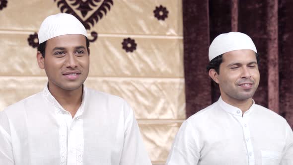Two Muslim men smiling