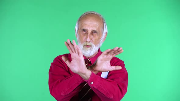 Portrait of Happy Old Aged Man 70s Strictly Gesturing with Hands Crossed Making X Shape Meaning