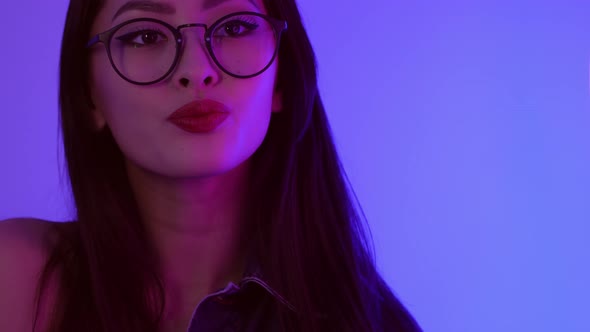 Studio Portrait of Asian Woman with Neon Lights