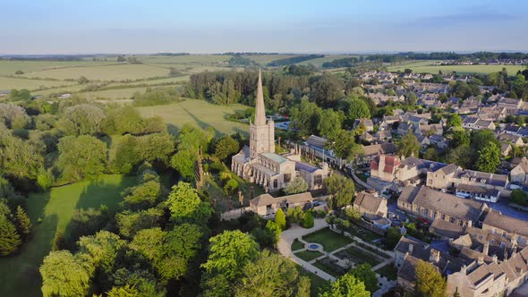 Aerial Drone View of Cotswolds Village and Burford Church in England, a Popular English Picturesque