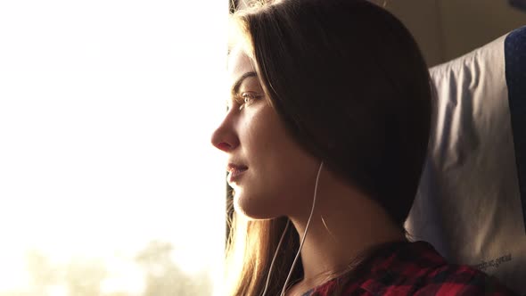 Side View of a Beautiful Caucasian Girl Going Somewhere By Train