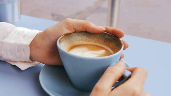 Businesswoman having cup of coffee