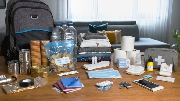 Emergency backpack equipment organized on the table