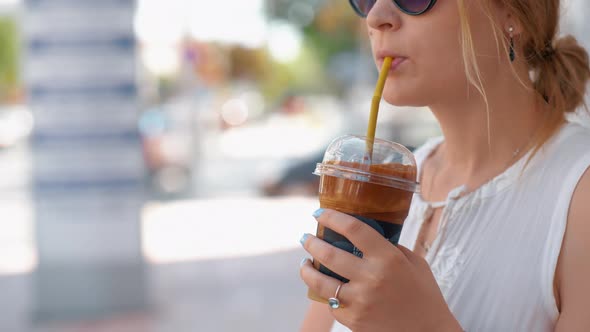 Woman Having Chocolate Drink in the Street