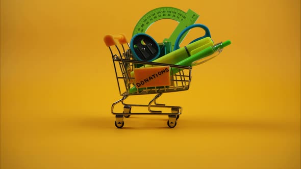 Donations of School Supplies in Shopping Cart. Stop Motion