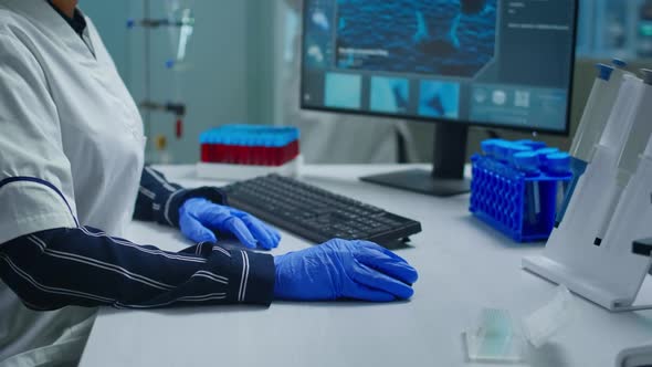 Portrait of a Smiling Chemist Wearing Safety Glasses in Lab Looking at Camera