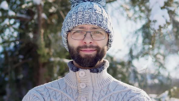 Portrait of a Bearded Man in a Winter Knitted Hat