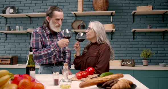 Senior Couple Tasting Wine in the Kitchen