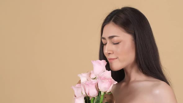 Beautiful woman smell flower