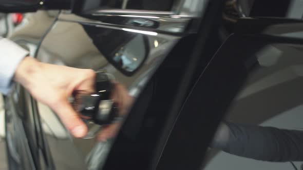 Close-up of Man's Hand Opens Car Door