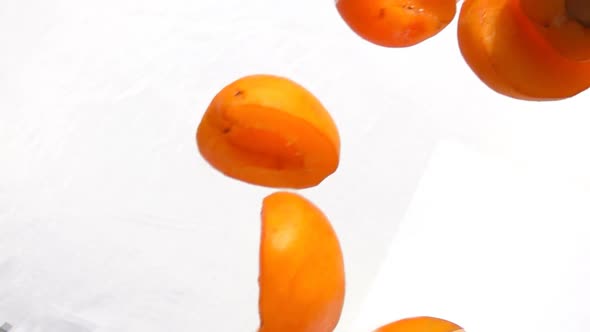 Halves Ripe Apricots Fly on White Background