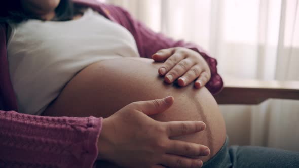 Happy Pregnant Woman and Expecting Baby at Home