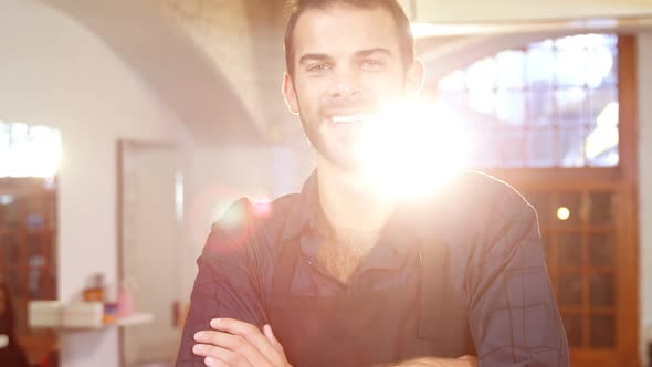 Male hairdresser smiling in hair salon