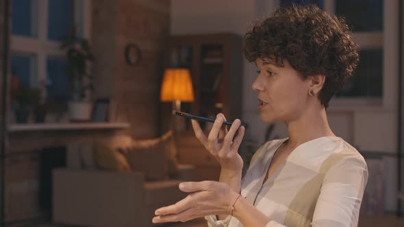 Woman Talking on Mobile Phone at Home