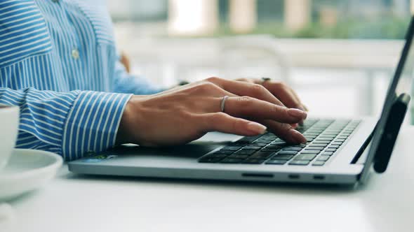 Close Up of Female Manicured Hands Typing on a Laptop