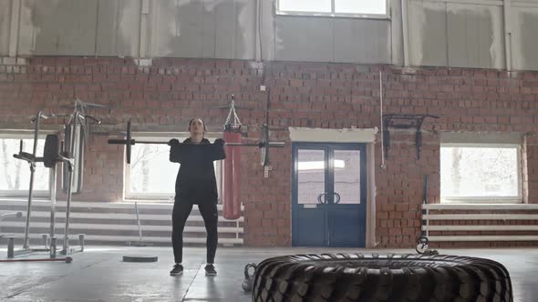 Woman Doing Barbell Raises Over Head