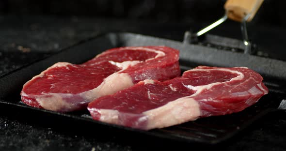 Steak Raw Beef Ribeye in a Frying Pan.