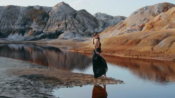 Beautiful woman posing on other-worldly hilly landscape
