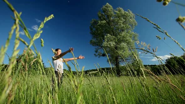 Woman doing yoga in the middle of a field of high grass