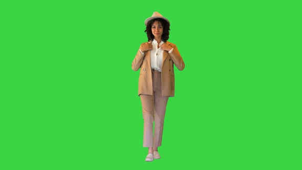 Cheerful African American Lady in a Hat Smiling on Camera on a Green Screen Chroma Key