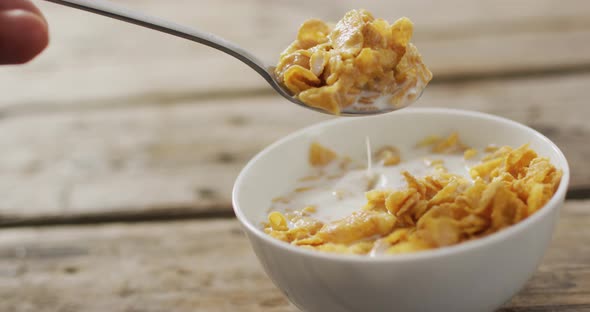 Video of cereals in ceramic bowl on wooden kitchen worktop