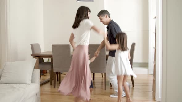 Cheerful Parents and Kids Playing Active Games at Home