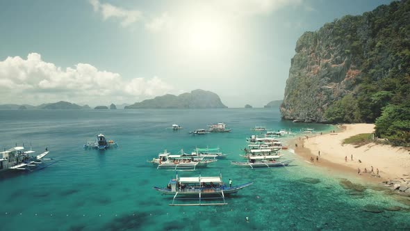 Aerial View of Passenger Boats Tourists Rest at Ocean Sand Coast of Palawan Harbor Philippines alt