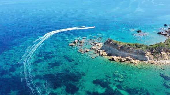 Aerial View of a Motor Boat Towing a Tube. Zakynthos, Greece