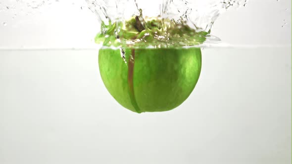 Super Slow Motion Fresh Juicy Apple Falls Into the Water with Splashes