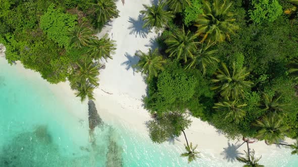 Aerial drone shot abstract of paradise seashore beach adventure by transparent ocean and white sandy