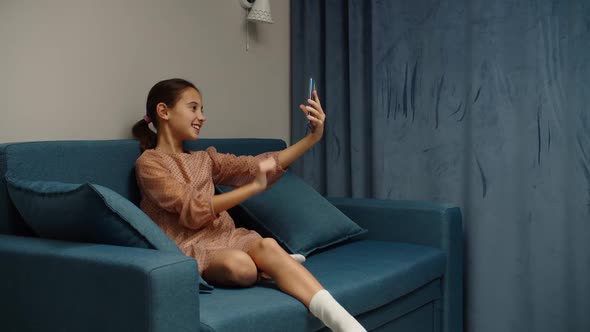 Preteen Girl Taking Selfie Using Mobile Phone Photo Messaging Indoors