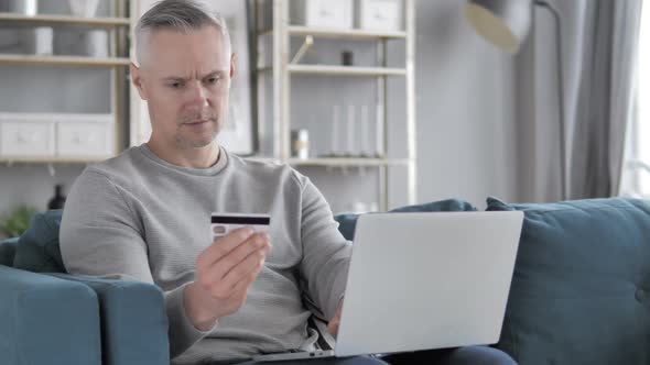 Online Shopping on Laptop By Casual Gray Hair Man Online Banking