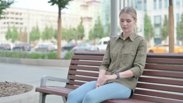 Woman standing and Leaving after Sitting on Bench Outdoor